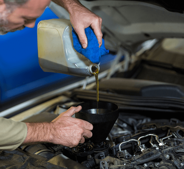 mechanic-pouring-oil-into-car-engine